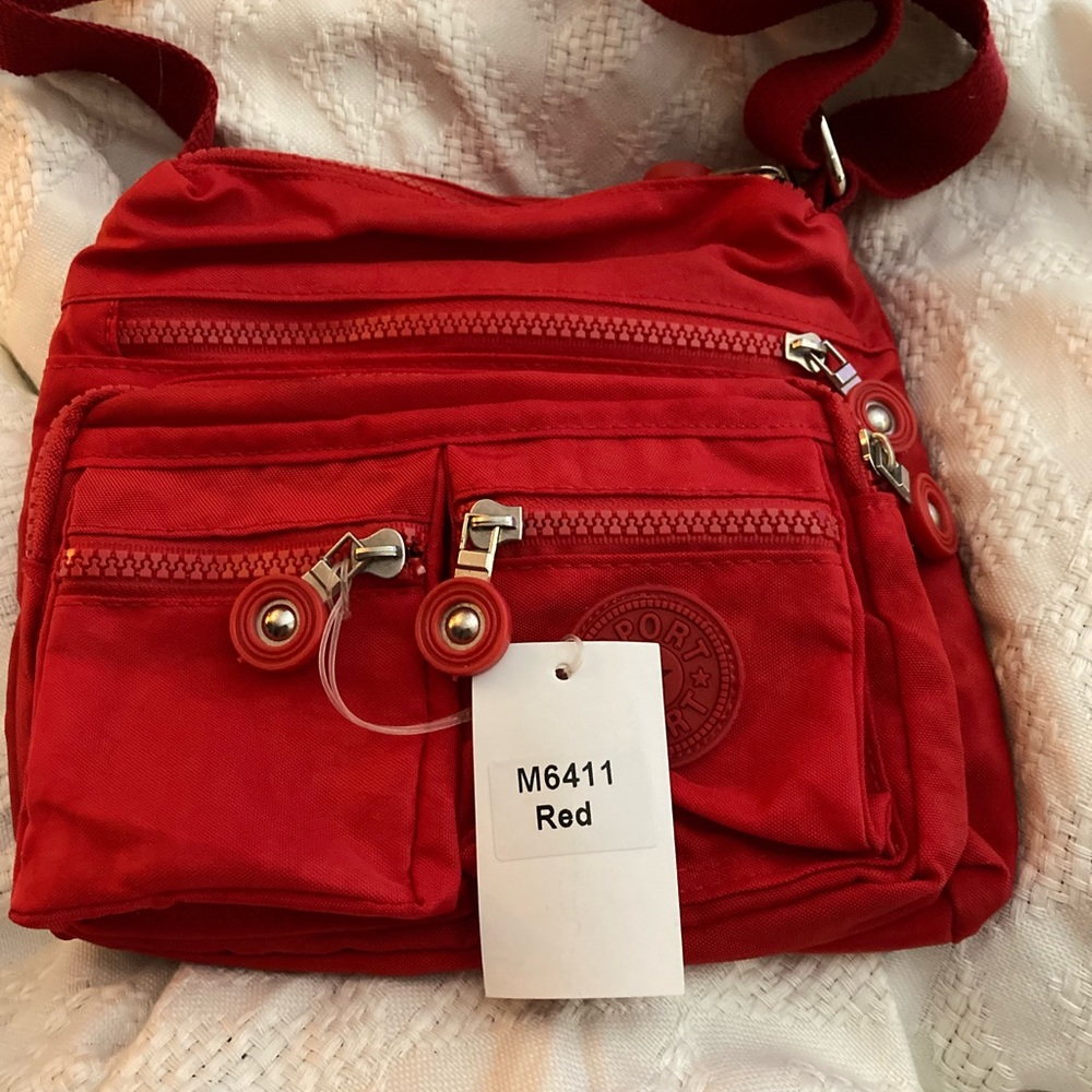 NWT Sport canvas multi zipper pockets with one Velcro pocket. Long adj. strap